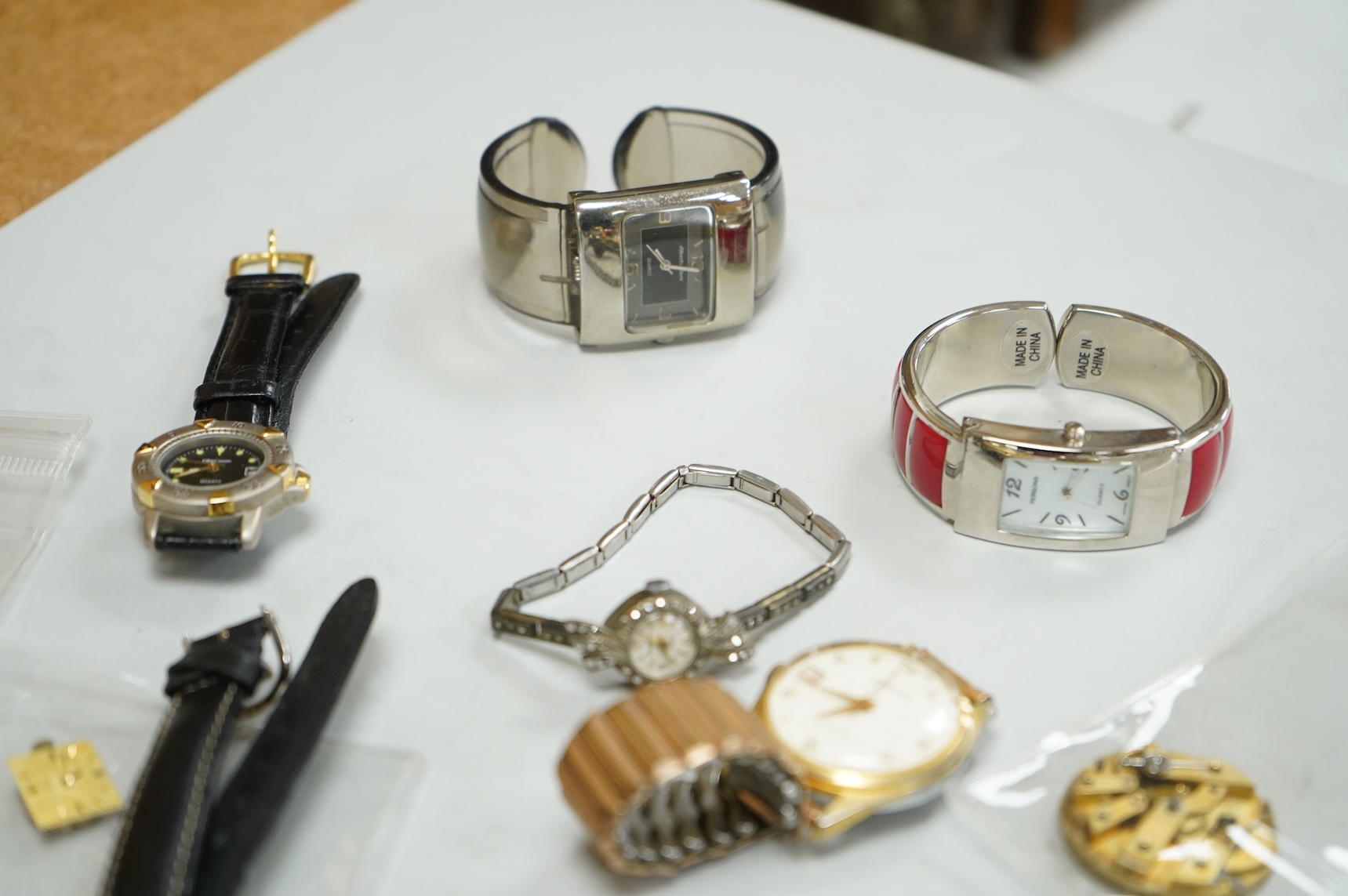 A small collection of assorted lady's and gentleman's wrist watches, including three Omega De Ville steel and gold plated quartz watches and wrist watches movements including Girard Perregaux.